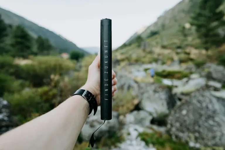 person holding black remote control