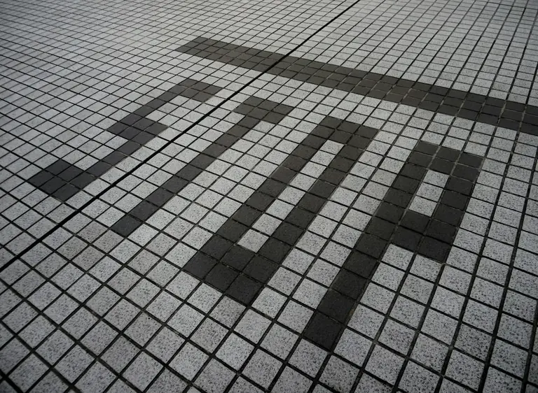shadows of people on a brick surface