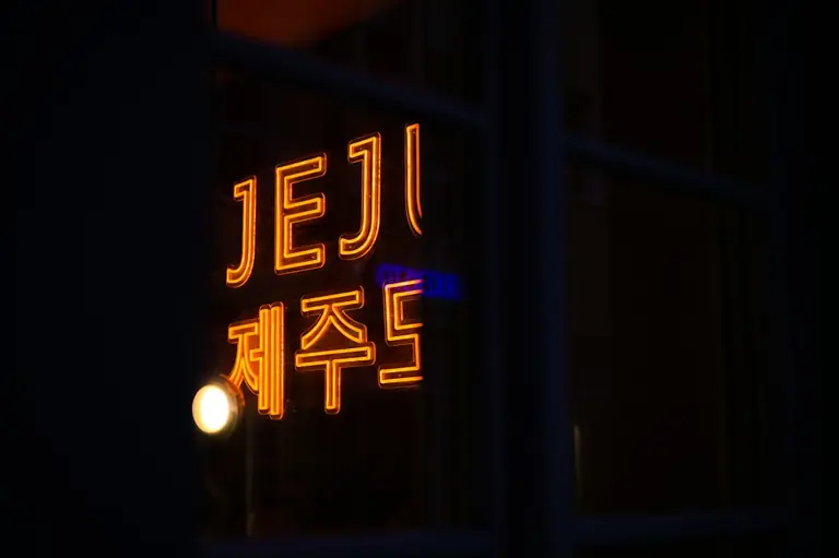 a neon sign that is on the side of a building